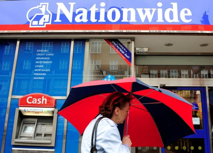 © Reuters. FILE PHOTO: A woman passes a branch of the Nationwide Building Society in London
