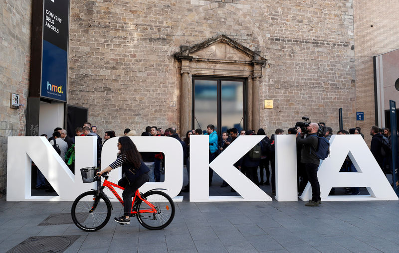 © Reuters. FILE PHOTO: A cyclist rides past a Nokia logo during the Mobile World Congress in Barcelona