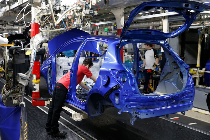 © Reuters. FILE PHOTO: Employees work on the assembly line to build Yaris cars at Toyota's automobile manufacturing plant in Onnaing