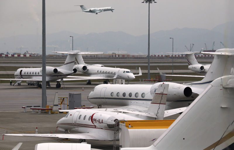 © Reuters. A business jet takes off as others are parked at the Hong Kong Airport