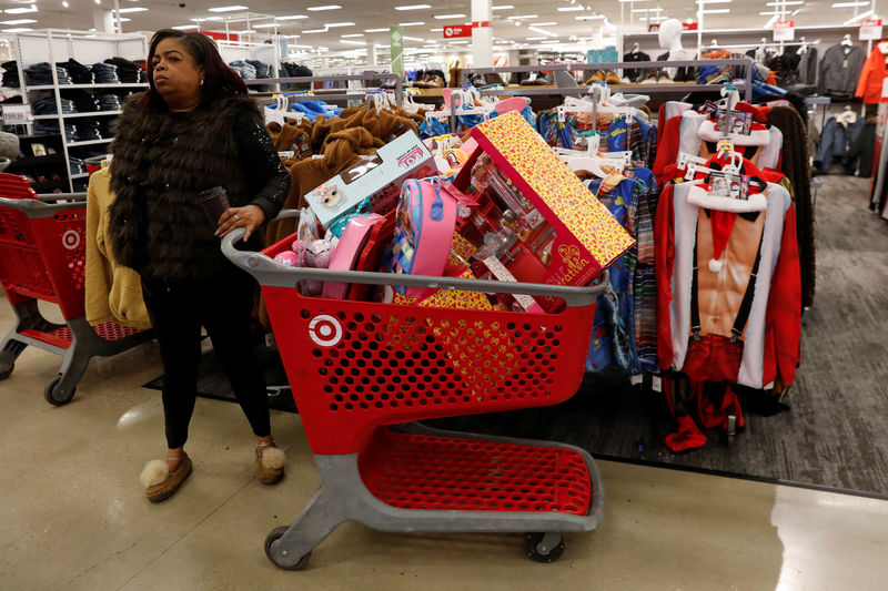 © Reuters. A woman stands with items inside a target store during a Black Friday sales event in Westbury, New York
