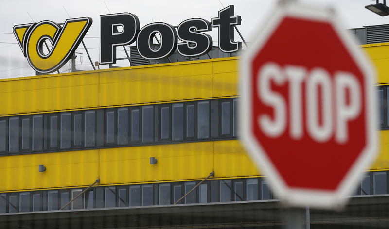 © Reuters. The logo of Austrian Post is pictured behind a traffic sign on the roof of Austrian Post logistics centre in Vienna