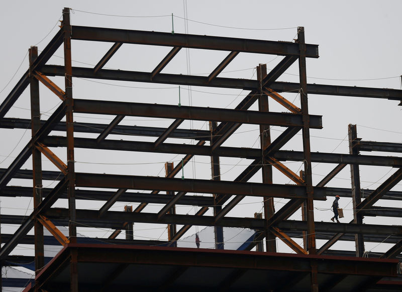 © Reuters. FILE PHOTO: A worker is seen at a construction site for a financial building in Seoul