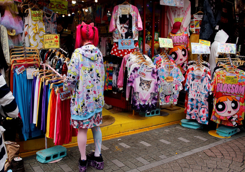 © Reuters. FILE PHOTO - A store staff member works at a clothing store in a shopping district in Tokyo