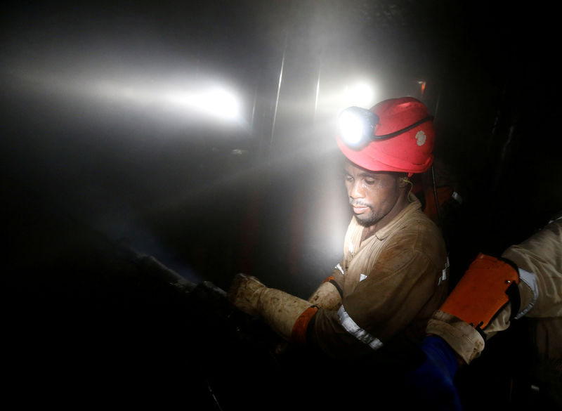 © Reuters. FILE PHOTO: Miners work deep underground at Sibanye Gold's Masimthembe shaft in Westonaria