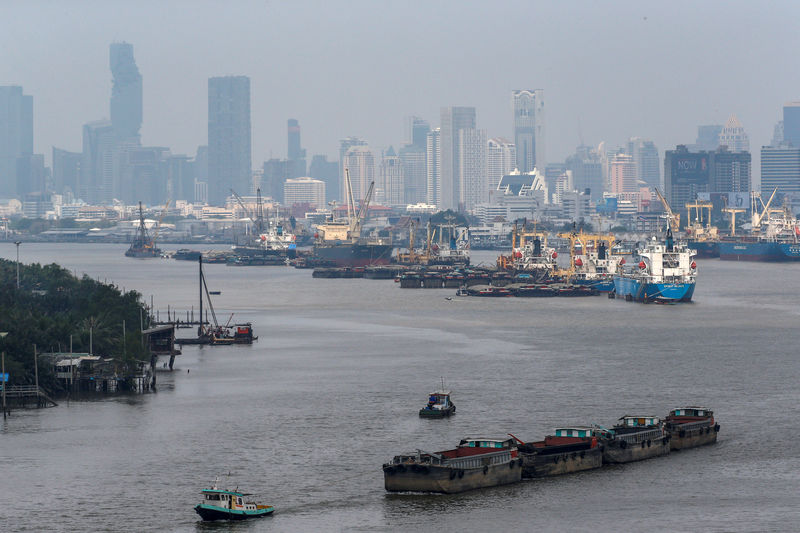 © Reuters. Cargo ships are pictured near the port in Bangkok