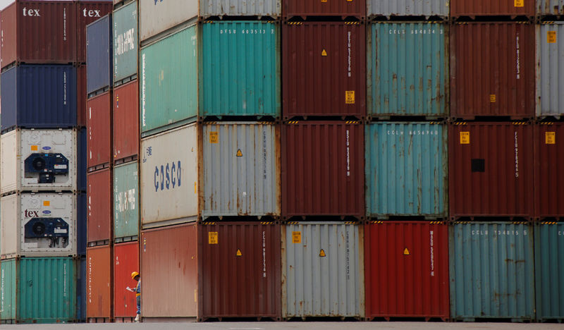 © Reuters. FILE PHOTO: A laborer works in a container area at a port in Tokyo