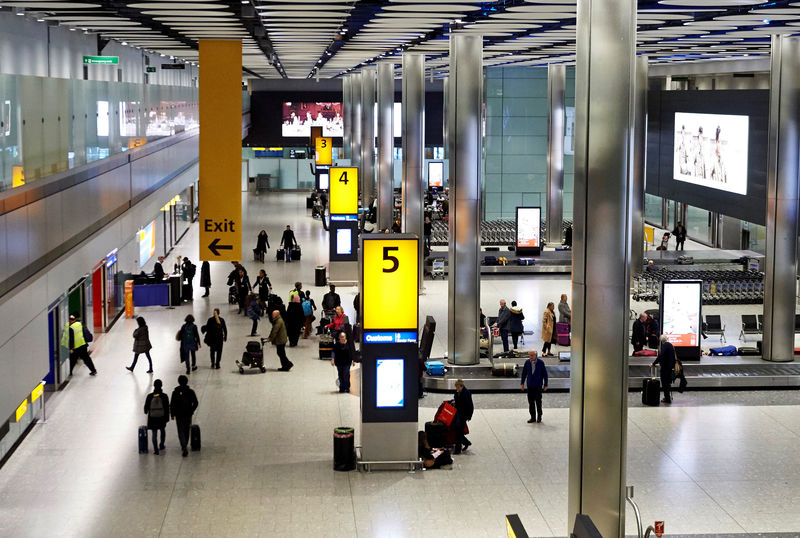 © Reuters. Passengers collect their luggage from the baggage reclaim area of Terminal 5 London Heathrow Airport in west London