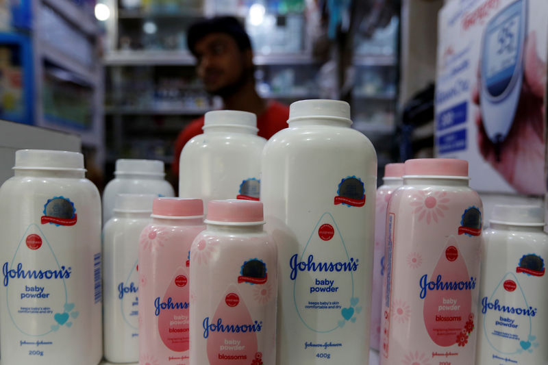 © Reuters. A worker waits for customers as bottles of Johnson & Johnson baby powder are displayed at a medical store in Kolkata