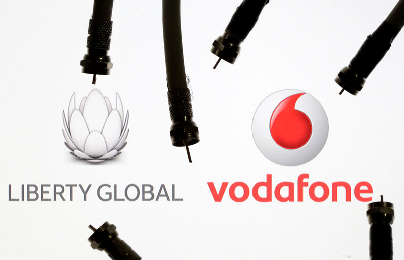 © Reuters. Coaxial TV Cables are seen in front of Vodafone and Liberty Global logos in this illustration