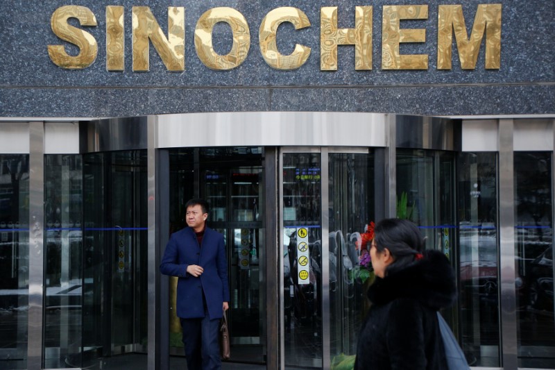 © Reuters. FILE PHOTO:  A man walks out of an office building of Sinochem in Beijing
