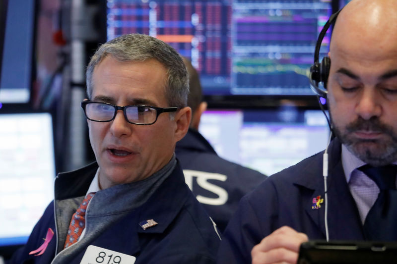 © Reuters. A trader looks at price monitors as he works on the floor at the New York Stock Exchange (NYSE) in New York City, New York