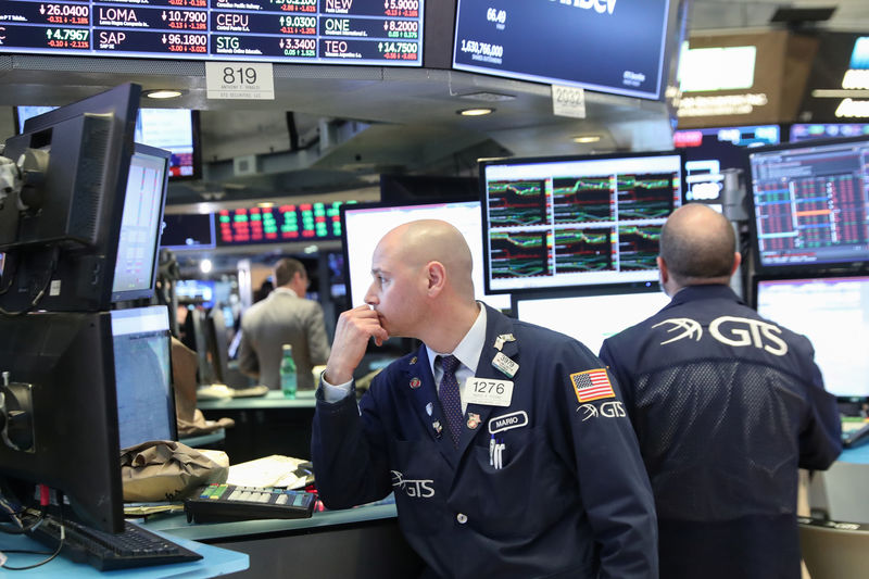 © Reuters. A trader looks at price monitors as he works on the floor at the New York Stock Exchange (NYSE) in New York City, New York