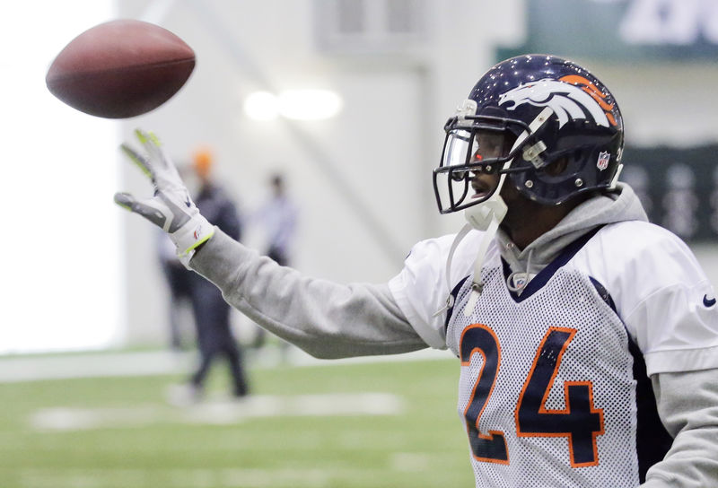 © Reuters. Denver Broncos cornerback Bailey tries a one-handed interception during their practice session for the Super Bowl in Florham Park