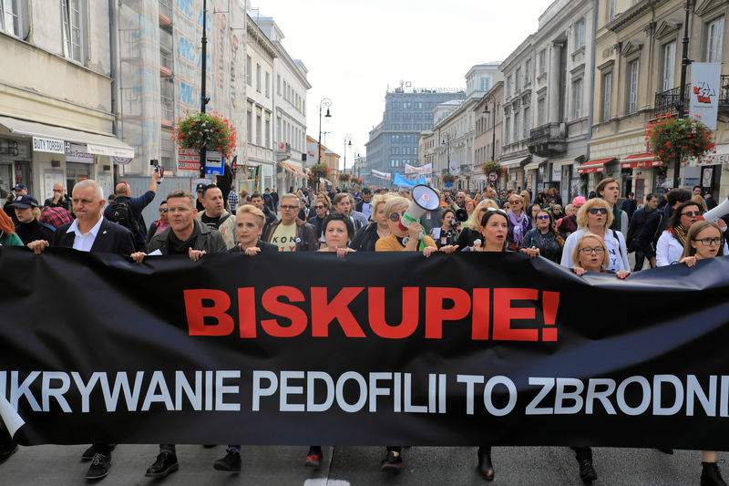 © Reuters. People take part during a demonstration against pedophilia 'Hands away from children' in Warsaw