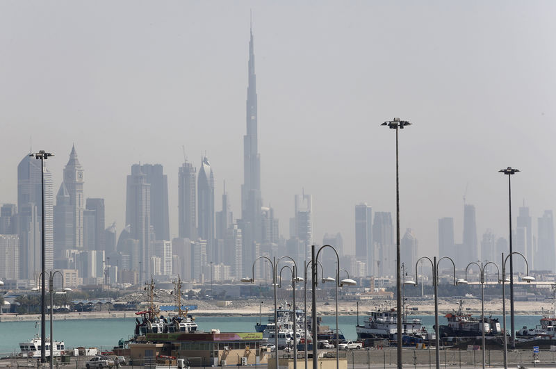 © Reuters. The skyline is seen with the Burj Khalifa as ships dock at Port Rashid, in Dubai