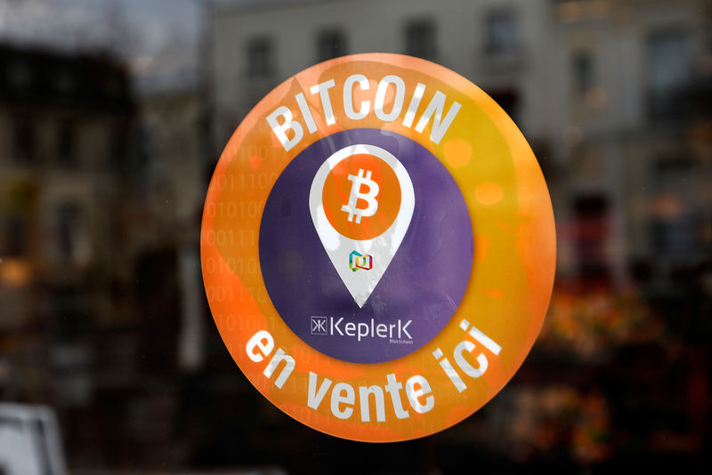 © Reuters. A sticker of French startup Keplerk, indicating that clients can purchase bitcoins, is seen on a tobacco shop at Rueil-Malmaison