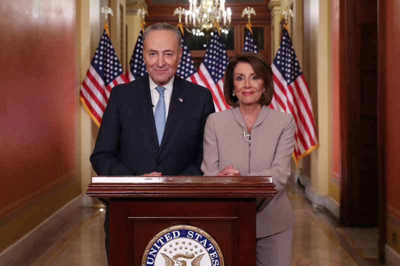 © Reuters. Speaker of the House Nancy Pelosi and Senate Minority Leader Chuck Schumer pose after concluding their joint response to President Trump's prime time address on Capitol Hill in Washington