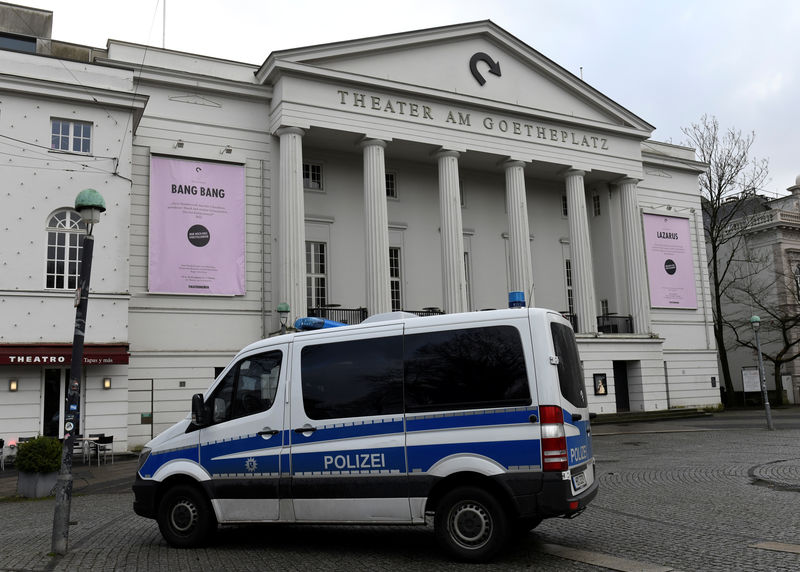 © Reuters. A police car stands in front of the theatre while police forces examine the crime scene at the back-side, where far-right Alternative for Germany (AfD) party member Frank Magnitz was attacked by unknown assailants, in Bremen