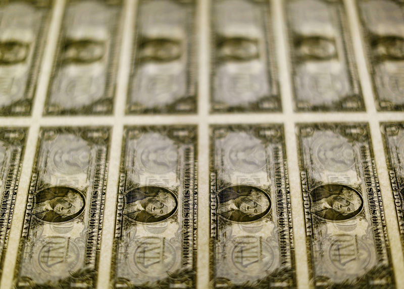 © Reuters. FILE PHOTO: United States one dollar bills seen on a light table at the Bureau of Engraving and Printing in Washington