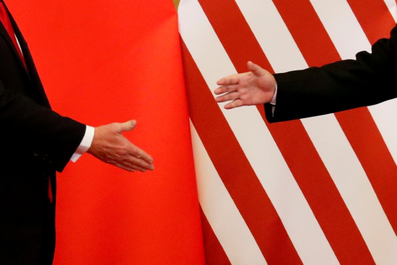 © Reuters. FILE PHOTO: FILE PHOTO: U.S. President Donald Trump and China's President Xi Jinping shake hands after making joint statements at the Great Hall of the People in Beijing