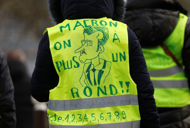 © Reuters. A protester wearing a yellow vest attends a demonstration with French unions against the French government policies in front of the sport hall "La Maison du Handball" during a visit of French President Emmanuel Macron in Creteil