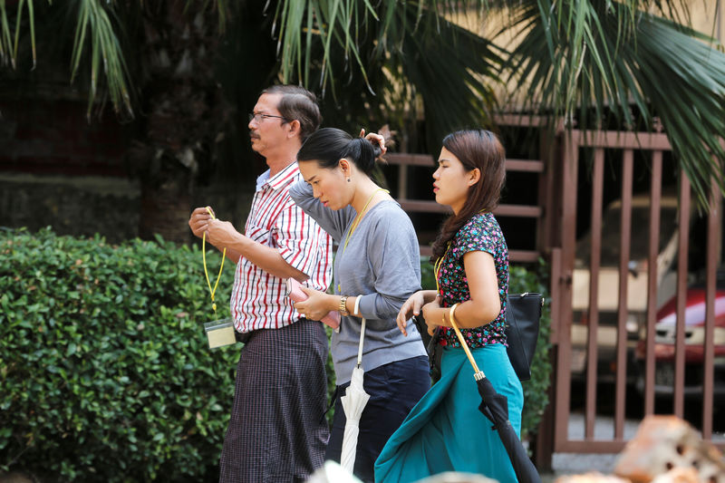 © Reuters. The families of jailed Reuters reporters arrive at the High Court ahead of the ruling in Yangon