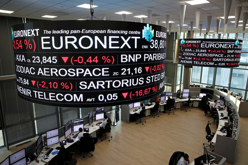 © Reuters. FILE PHOTO: Company stock price information is displayed on screens as they hang above the Paris stock exchange, operated by Euronext NV, in La Defense business district in Paris