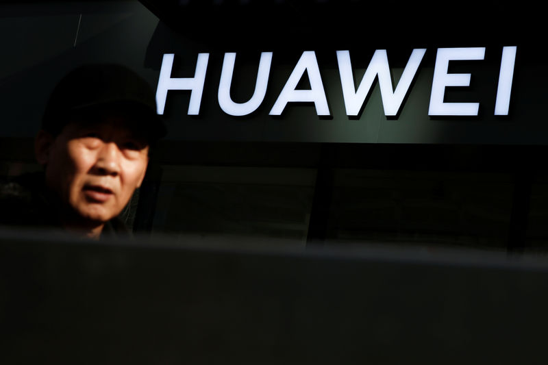 © Reuters. Homem passa por uma loja da Huawei em Pequim