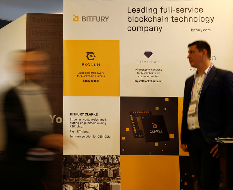 © Reuters. Delegates walk near an exhibition stand of Bitfury, a full-service blockchain technology company, at the Malta Blockchain Summit in St Julian's