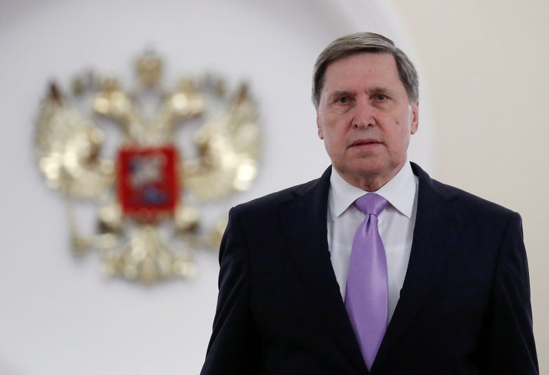 © Reuters. FILE PHOTO - Russia's presidential aide Ushakov approaches the media after a meeting of President Putin with U.S. National Security Adviser Bolton in Moscow