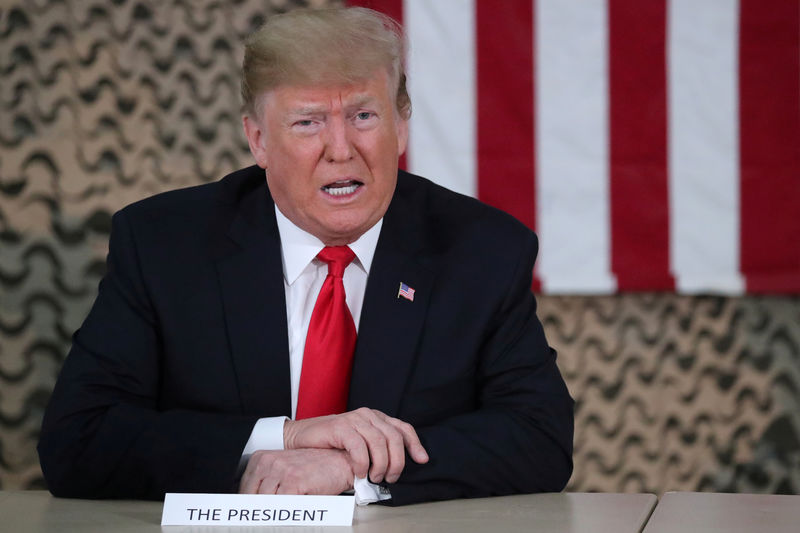 © Reuters. FILE PHOTO: U.S. President Trump speaks to reporters during an unannounced visit to Al Asad Air Base