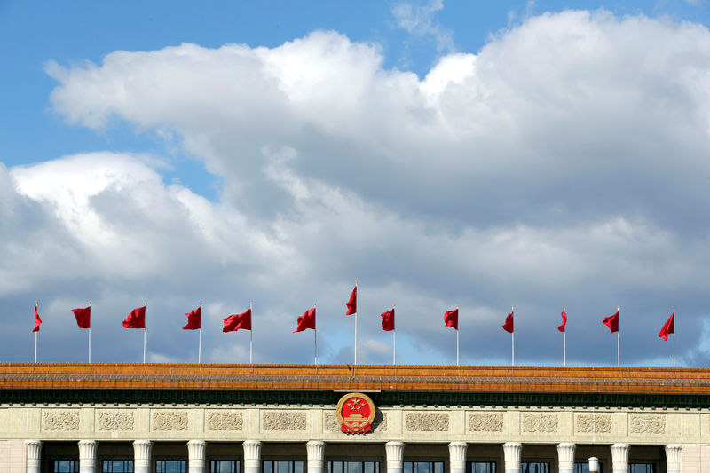 © Reuters. Red flags flutter on the top of the Great Hall of the People in Beijing