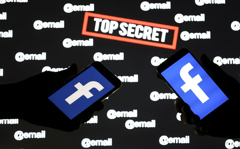 © Reuters. FILE PHOTO: Persons hold smartphones with the Facebook logo in front of displayed "top secret" and "email" words in this picture illustration