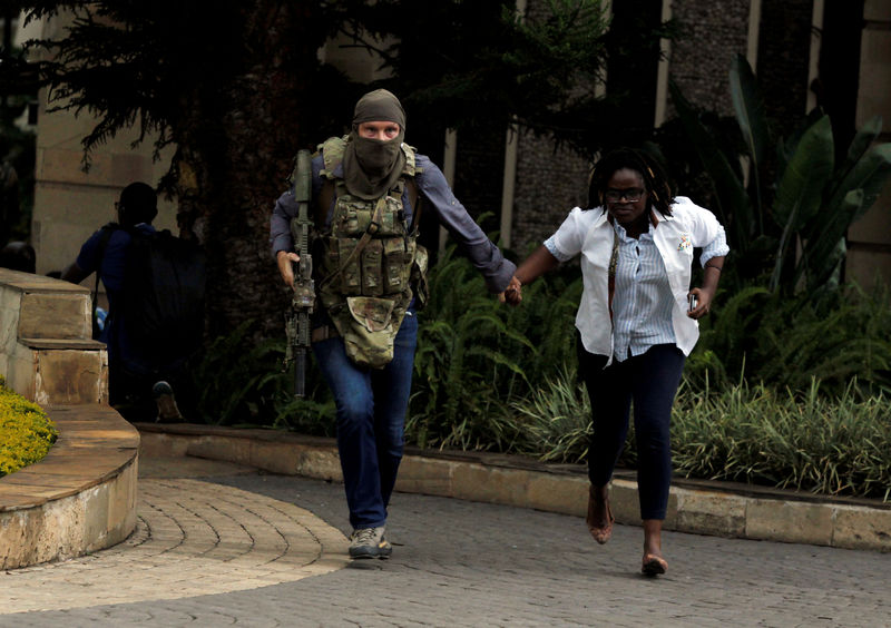 © Reuters. FILE PHOTO: A security agent evacuates an injured woman from the scene where explosions and gunshots were heard at the Dusit hotel compound, in Nairobi