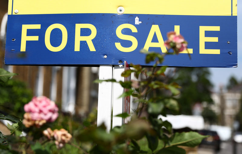 © Reuters. FILE PHOTO: An estate agent board is displayed outside a property in London