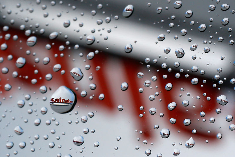 © Reuters. FILE PHOTO: A Sainsbury's sign is seen reflected in raindrops on a window in London