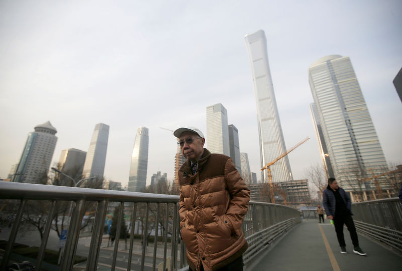 © Reuters. People walk through an overpass near Beijing's central business area