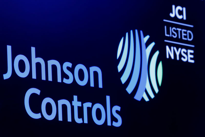 © Reuters. The logo and trading symbol for Johnson Controls International is displayed on a board on the floor of the NYSE in New York
