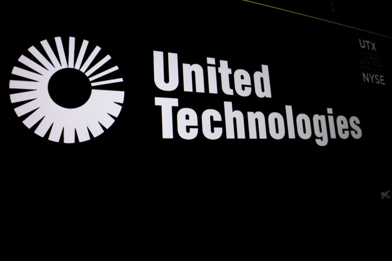 © Reuters. United Technologies logo is displayed on a screen at the post where it's stock is traded on the floor of the NYSE in New York