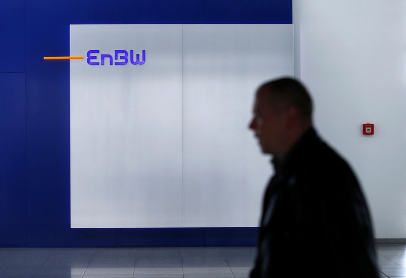 © Reuters. A man walks past a logo of German power supplier EnBW Energie Baden-Wuertemberg AG in the companies headquarters in Karlsruhe