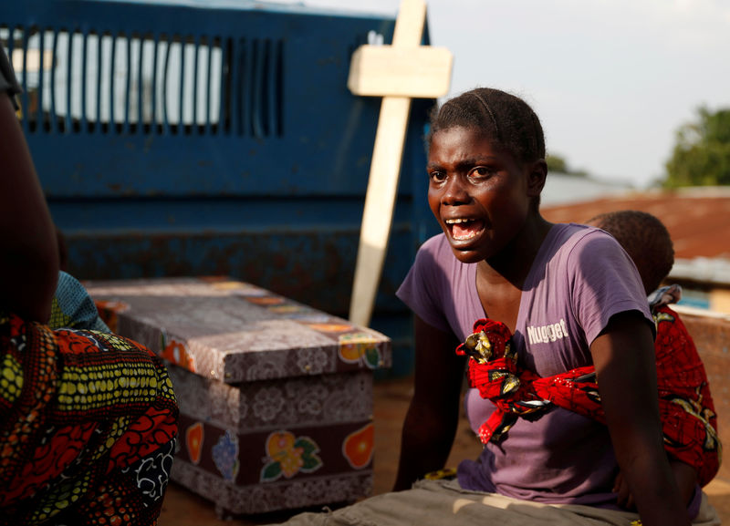 FILE PHOTO: A woman cries during the funeral of a child, suspected of dying...