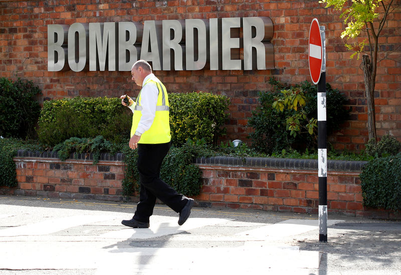 © Reuters. FILE PHOTO: A worker walks past the entrance to the Bombardier plant in Derby, Britain