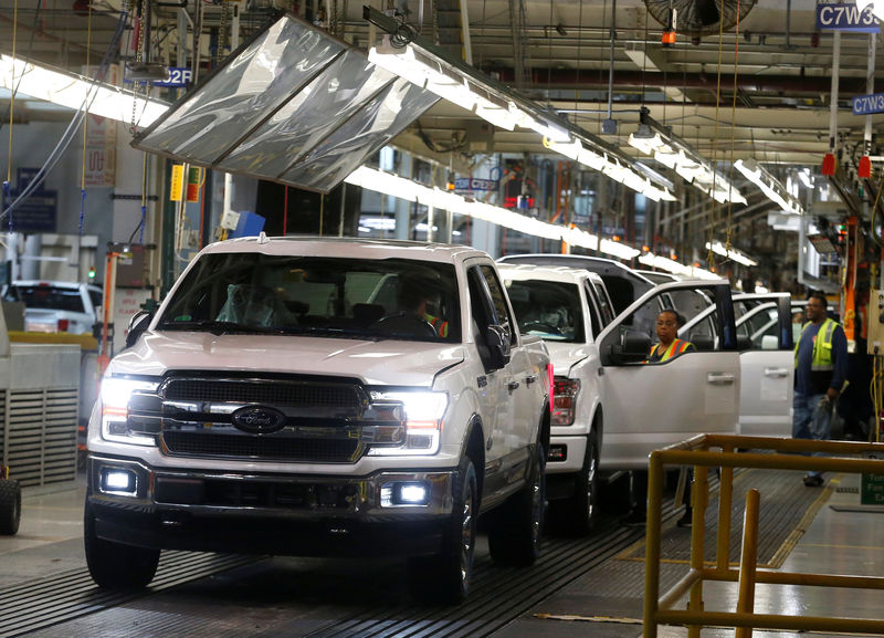 © Reuters. FILE PHOTO - Newly assembled Ford F150 pick-up trucks are driven off the assembly line during the 100-year celebration of the Ford River Rouge Complex in Dearborn