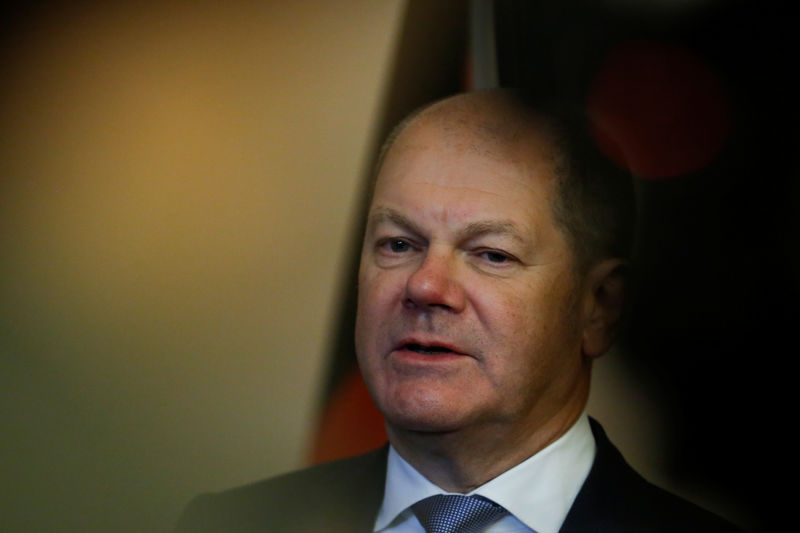 © Reuters. German Finance Minister Olaf Scholz attends a media briefing during his visit to Beijing