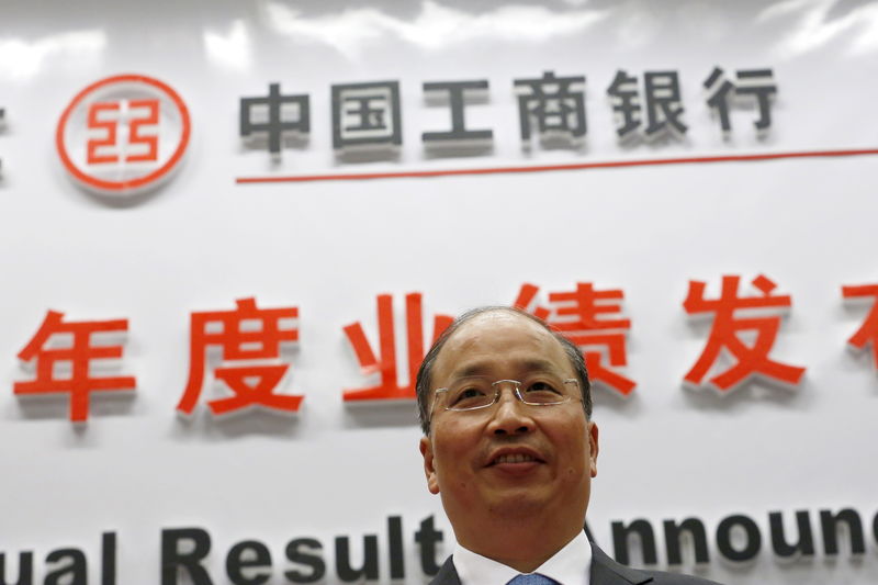 © Reuters. Industrial and Commercial Bank of China Ltd (ICBC)'s president Yi Huiman poses to photographers as he arrives at a news conference about its annual result announcement at its headquarters in Beijing