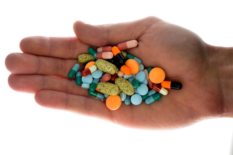 © Reuters. FILE PHOTO: A person holds pharmaceutical tablets and capsules in illustration picture in Ljubljana