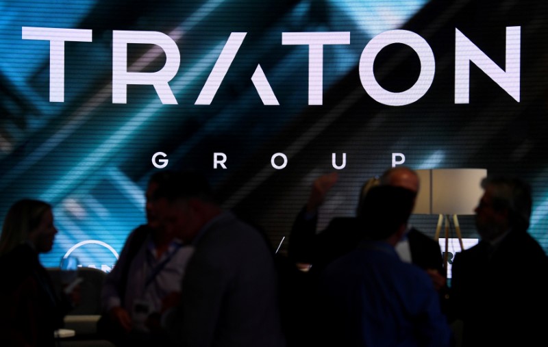 © Reuters. FILE PHOTO: Visitors stand at booth of VW's truck unit Traton Group in Hanover