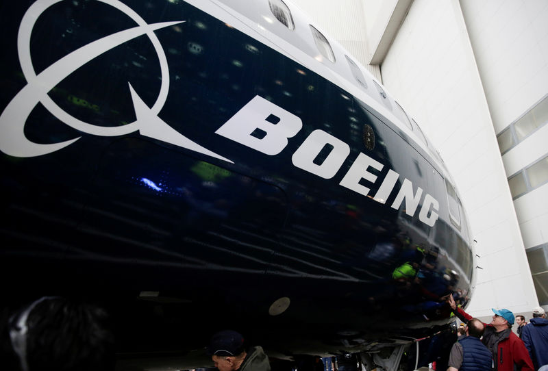 © Reuters. FILE PHOTO: Employees are pictured as the first Boeing 737 MAX 7 is unveiled in Renton