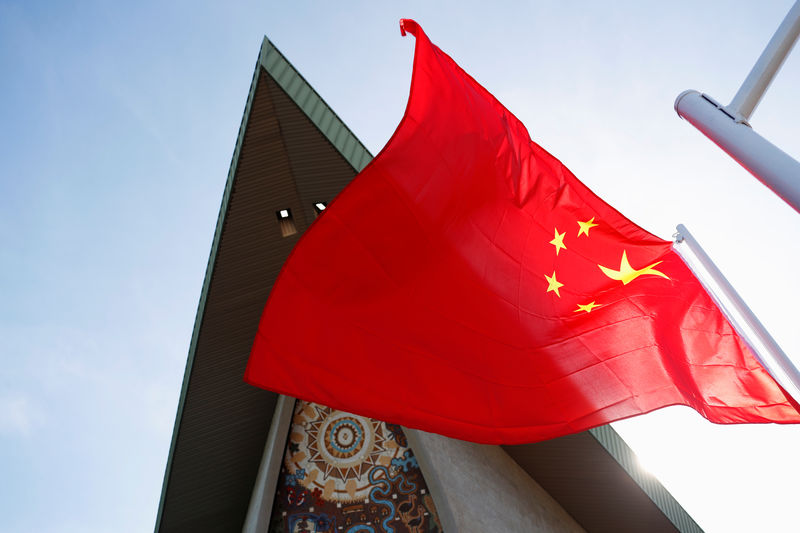 © Reuters. A Chinese national flag flies in front of Parliament House